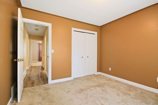 604 Adens Woods Ct, Columbia, MO 65201 - unfurnished bedroom with carpet floors, crown molding, and a closet