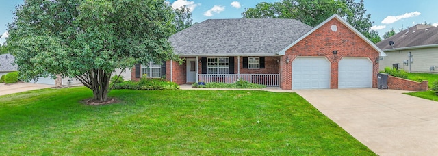 604 Adens Woods Ct, Columbia, MO 65201 - view of front of home with covered porch, an attached garage, concrete driveway, a front lawn, and brick siding