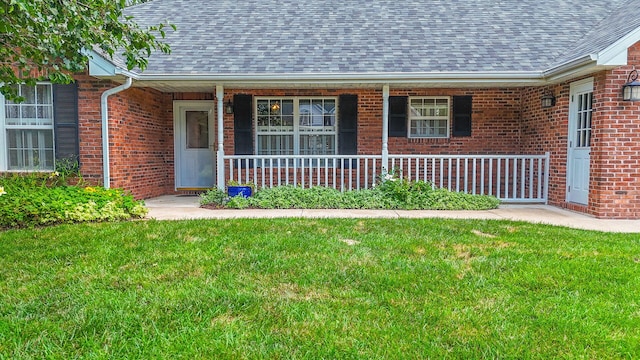 604 Adens Woods Ct, Columbia, MO 65201 - view of front facade featuring roof with shingles, brick siding, a porch, and a front yard