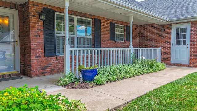 604 Adens Woods Ct, Columbia, MO 65201 - entrance to property featuring covered porch, brick siding, and a shingled roof