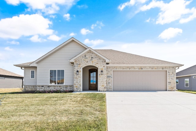 view of front of property with a garage and a front yard