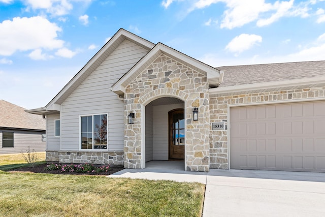 view of front of house with a front yard and a garage