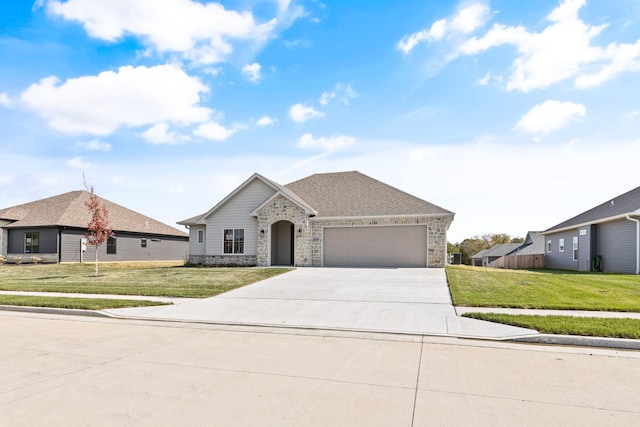 ranch-style home with a garage and a front lawn