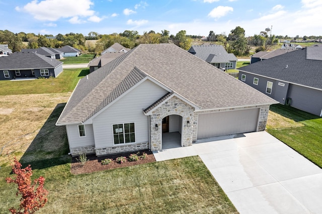 view of front of property with a garage and a front lawn