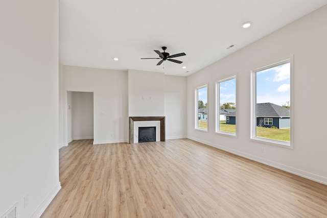 unfurnished living room with light hardwood / wood-style flooring and ceiling fan