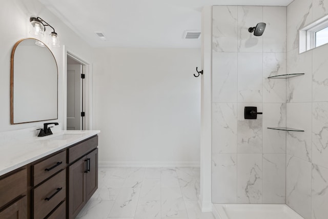 bathroom with vanity and a tile shower