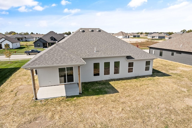 rear view of house featuring a yard