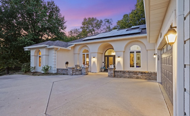 view of front of property with solar panels