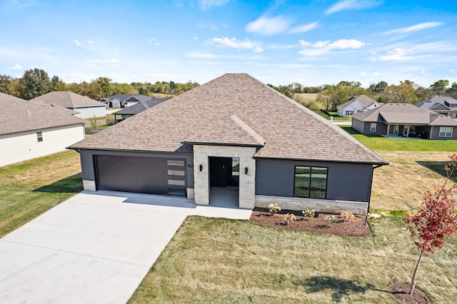 view of front of house featuring a front yard and a garage