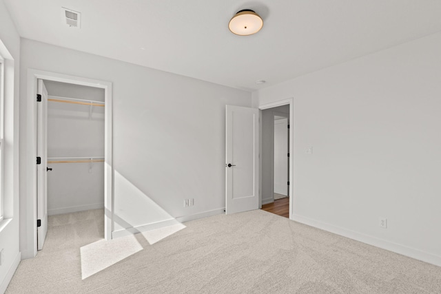 unfurnished bedroom with a closet and carpet flooring