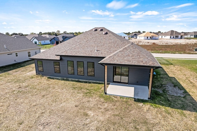 back of house with a yard