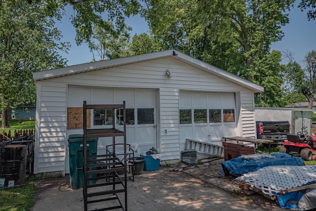 back of house featuring a garage and an outdoor structure