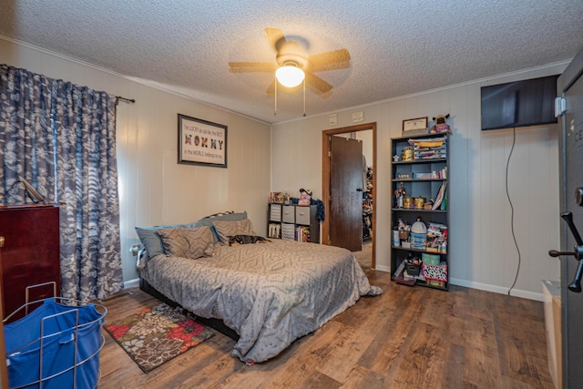 bedroom with wood-type flooring, a textured ceiling, ceiling fan, and crown molding