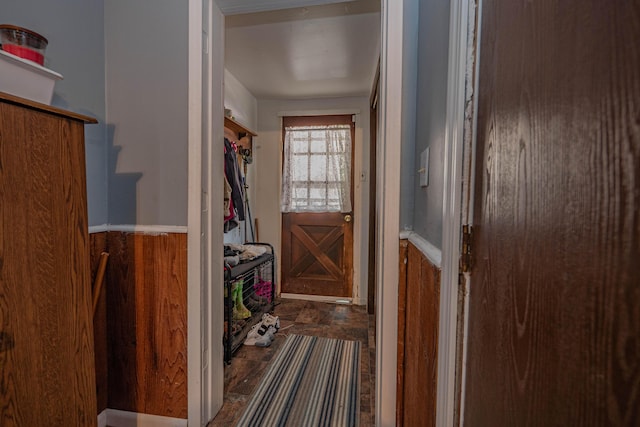 doorway featuring wooden walls