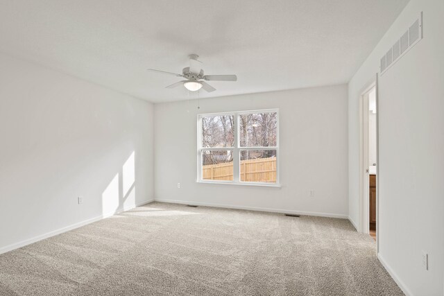 carpeted spare room with ceiling fan