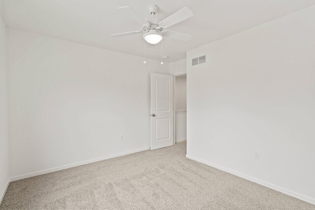 unfurnished room with ceiling fan and light colored carpet