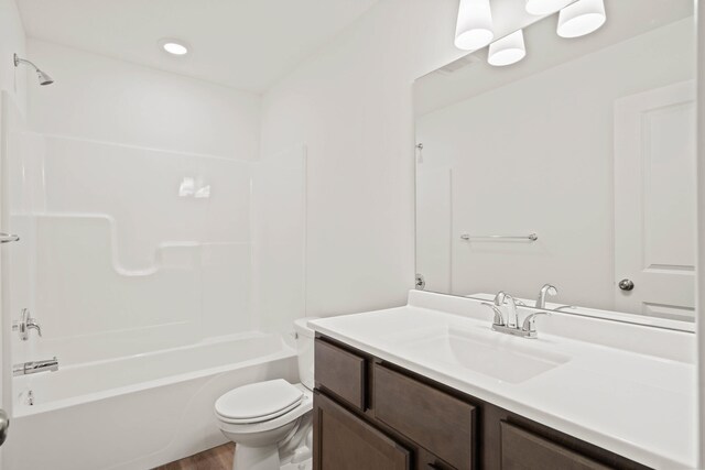 full bathroom featuring vanity, shower / bath combination, toilet, and hardwood / wood-style flooring