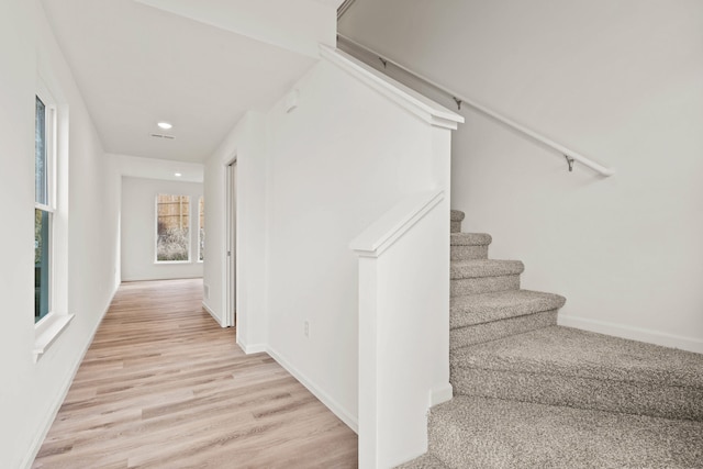 staircase with hardwood / wood-style flooring