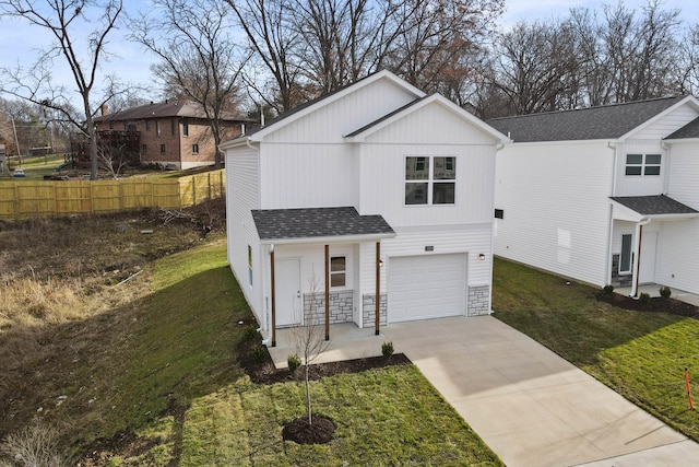 view of front of home with a front yard and a garage