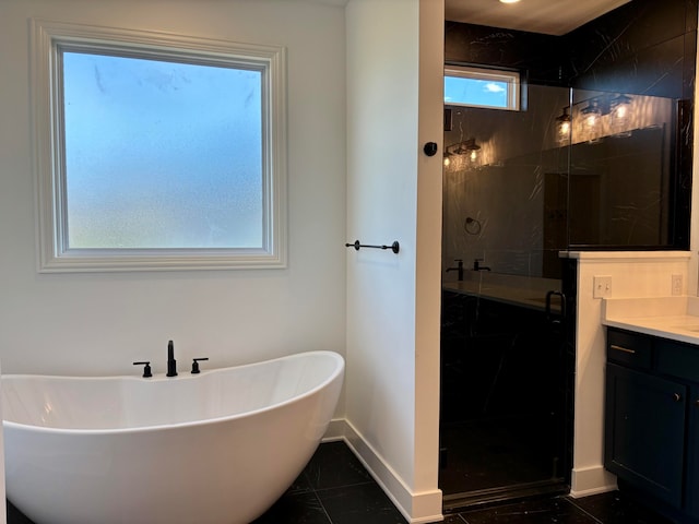 full bath with a freestanding tub, a shower stall, vanity, and baseboards