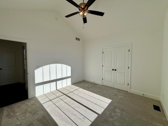 unfurnished room featuring high vaulted ceiling, visible vents, and light colored carpet