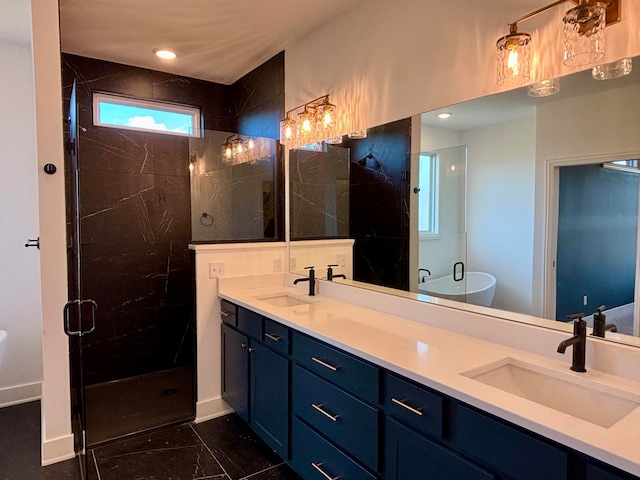 bathroom with double vanity, a stall shower, baseboards, and a sink