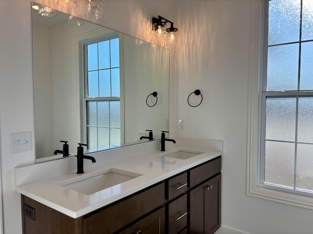 full bathroom with double vanity and a sink