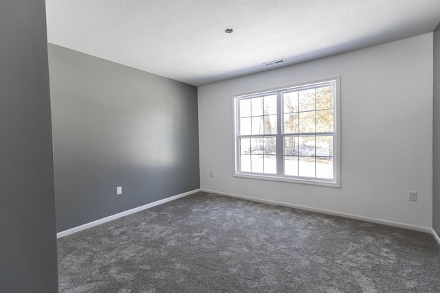 empty room featuring dark colored carpet