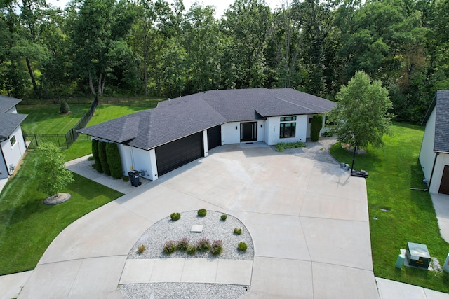 view of front of house with a garage and a front lawn