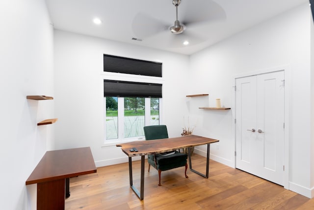 office with light hardwood / wood-style flooring and ceiling fan