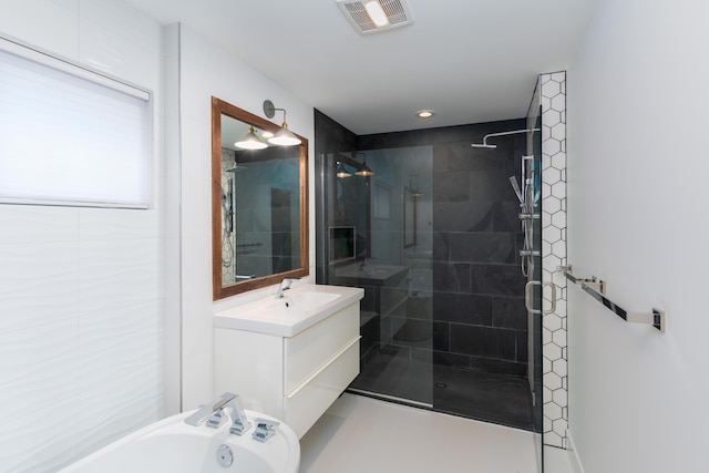 bathroom featuring independent shower and bath and vanity