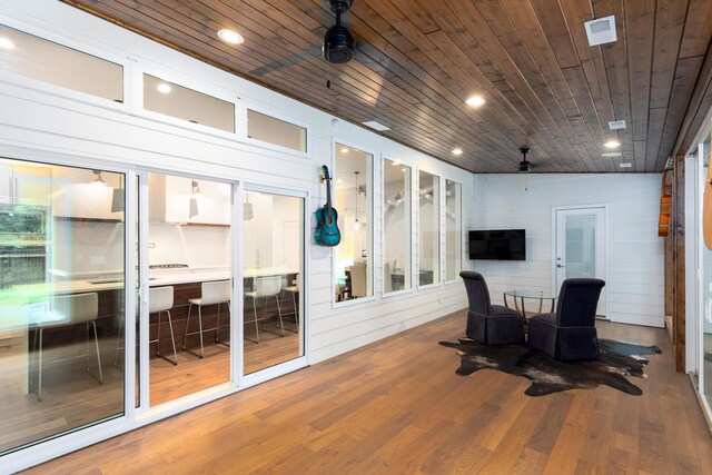 interior space featuring wooden ceiling, ceiling fan, and wood-type flooring