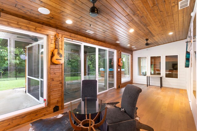 sunroom / solarium featuring wooden ceiling, ceiling fan, and lofted ceiling