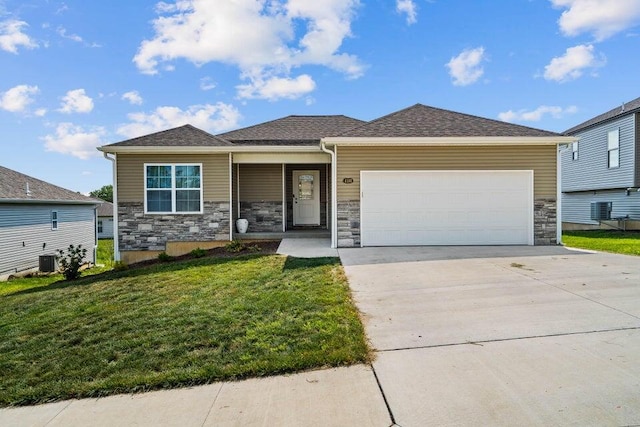 view of front facade featuring a garage, central AC unit, and a front yard