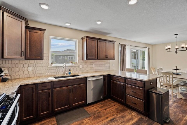 kitchen with sink, dishwasher, plenty of natural light, and dark wood-type flooring