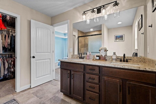 bathroom with an enclosed shower, tile patterned flooring, and dual bowl vanity