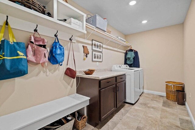 washroom featuring light tile patterned floors and washing machine and clothes dryer