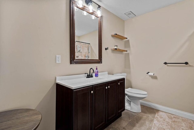 bathroom featuring tile patterned floors, vanity, and toilet