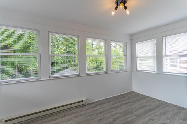 unfurnished sunroom featuring a baseboard radiator