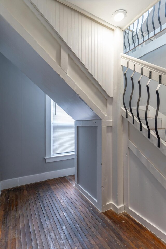 additional living space featuring hardwood / wood-style flooring and baseboards