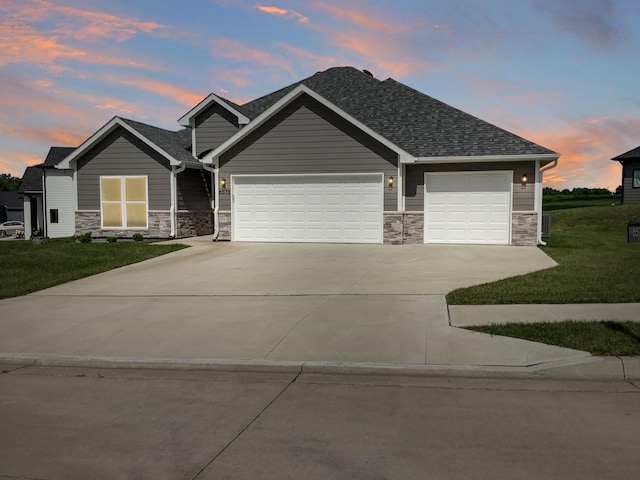 craftsman inspired home featuring a yard and a garage