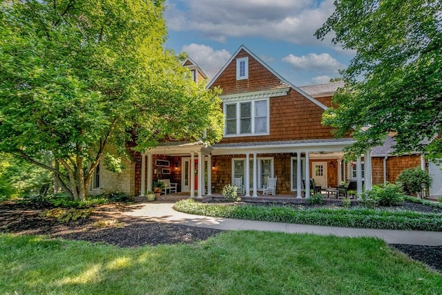 shingle-style home featuring covered porch