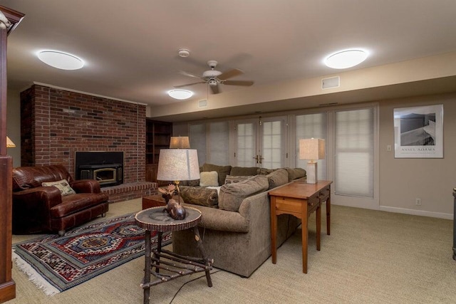 living room featuring light carpet, ceiling fan, visible vents, and baseboards