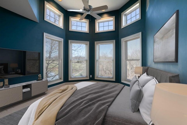 carpeted bedroom featuring a high ceiling