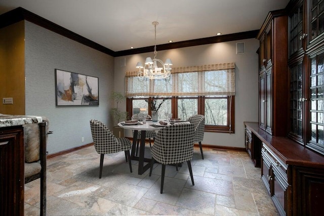 dining space with ornamental molding, stone tile flooring, and baseboards