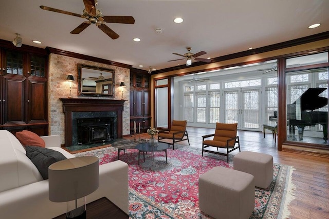 living area featuring ornamental molding, wood finished floors, and recessed lighting