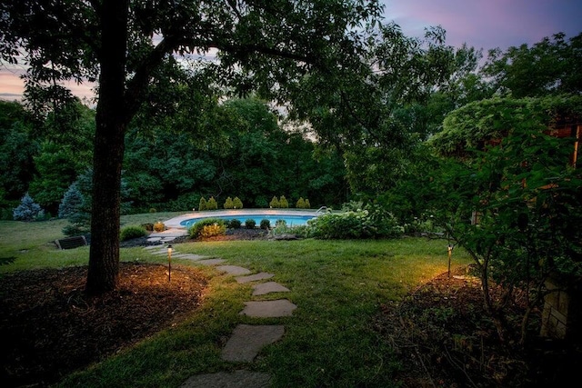 yard at dusk with an outdoor pool