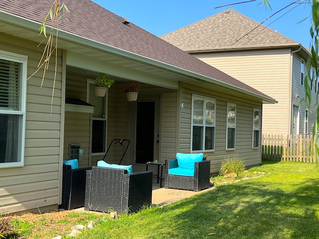 back of house with a lawn and a patio