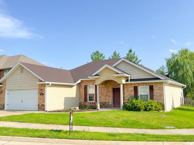 view of front of property featuring a garage and a front lawn