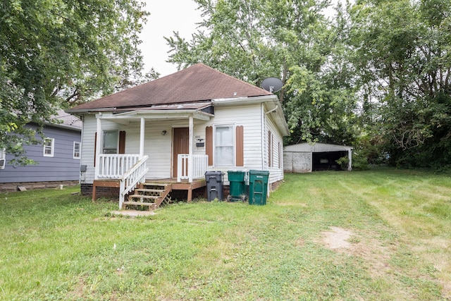 bungalow-style home with covered porch and a front yard